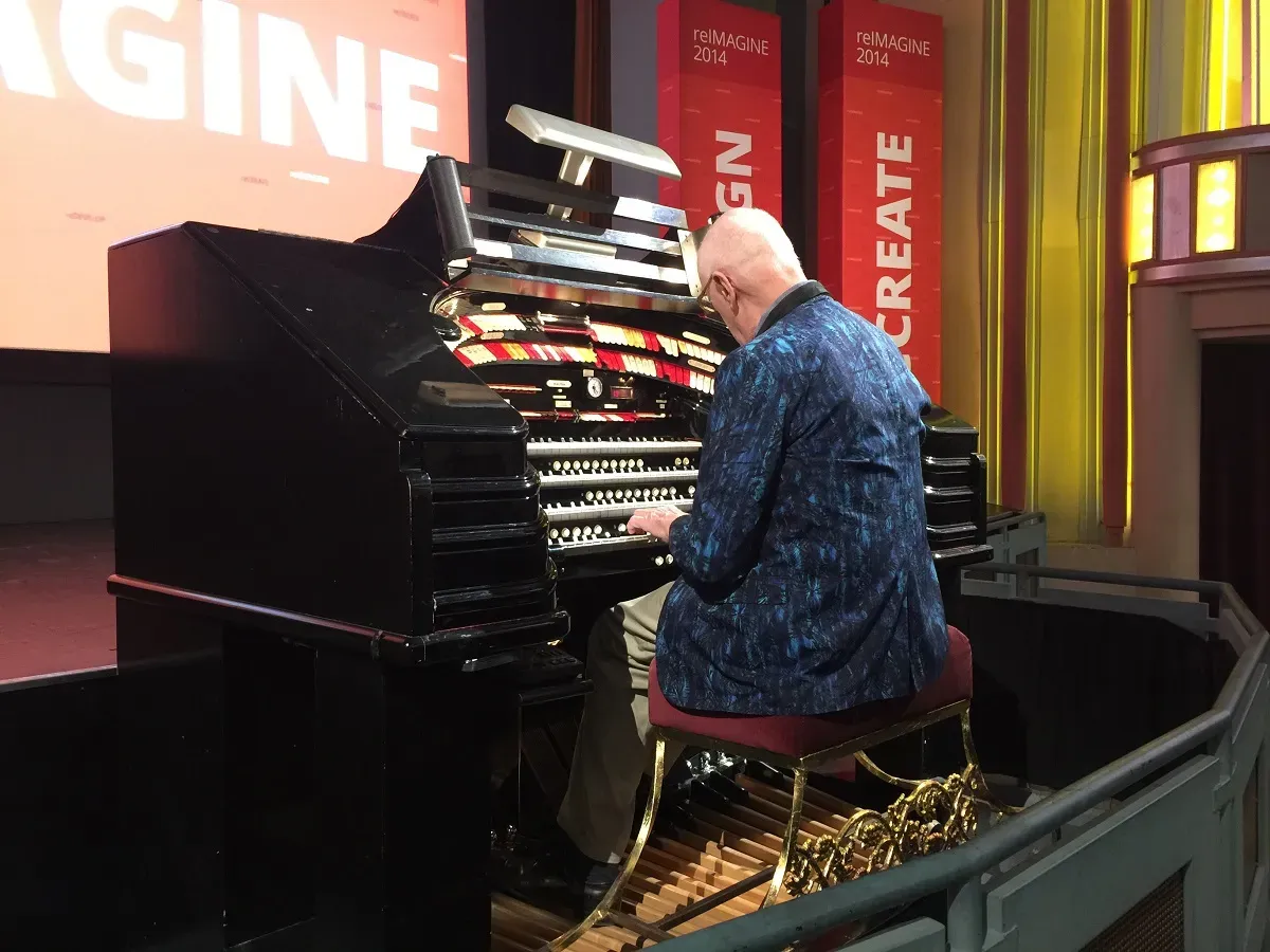 The organist playing at the front of the theatre.