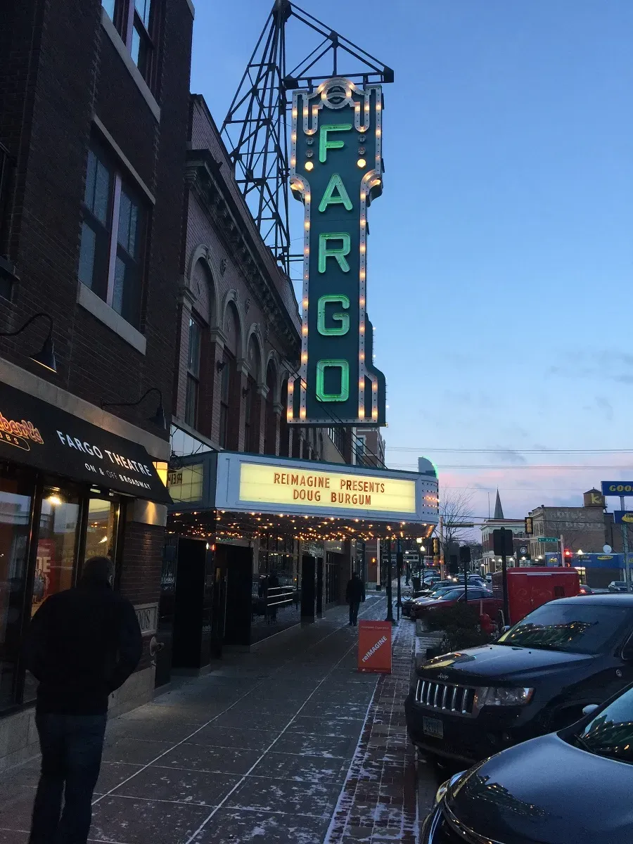 A picture of the Fargo Theatre, with the banner "reImagine presents Doug Burgum".